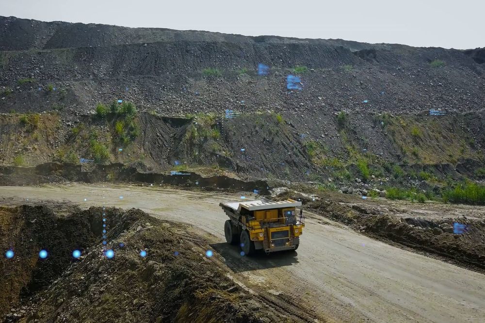 Haul truck on a road cut into the wall of an open pit